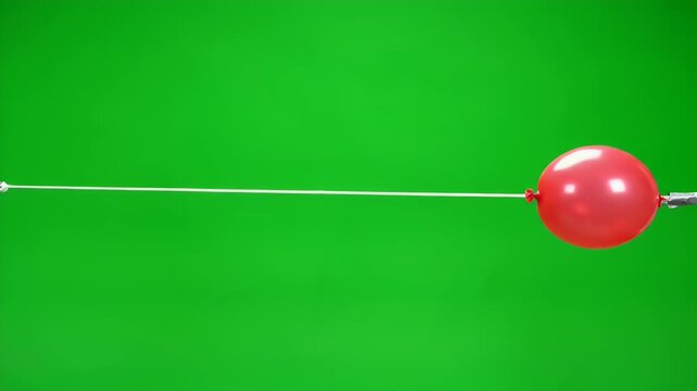 Red Balloon Rocket Experiment Sliding Along a Thin White String Against a Vibrant Green Background Demonstrating Physics Principles and Motion