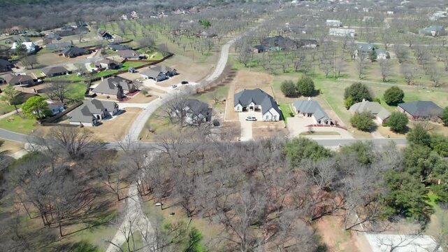 Aerial flight over Pecan Plantation near Granbury, Texas. Footage shows several houses and a lot of pecan trees.