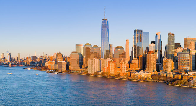 NYC aerial cityscape at dusk. New York City Hudson skyline at dusk. New York dusk metropolis. NYC panoramic view of Lower Manhattan skyline. New York City aerial skyline at dusk.