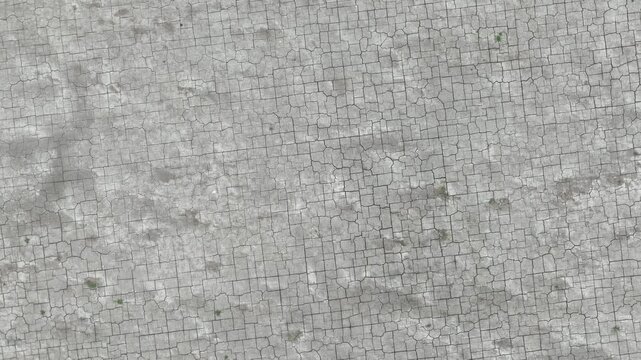 High-angle drone shot of parched earth with extensive cracks, illustrating climate change impacts, soil degradation, and the urgent need for effective water resource management.
