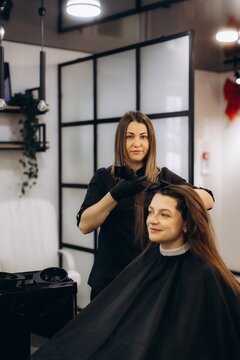 Hair stylist applying hair dye coloring treatment