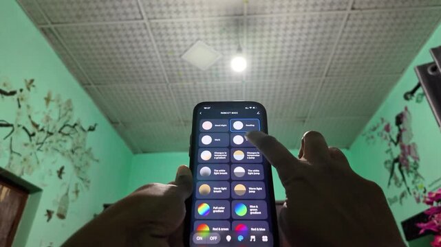 User browsing and selecting different lighting modes on smartphone to control a smart bulb. Demonstrates versatile home automation, preset lighting scenes, and modern digital lifestyle.