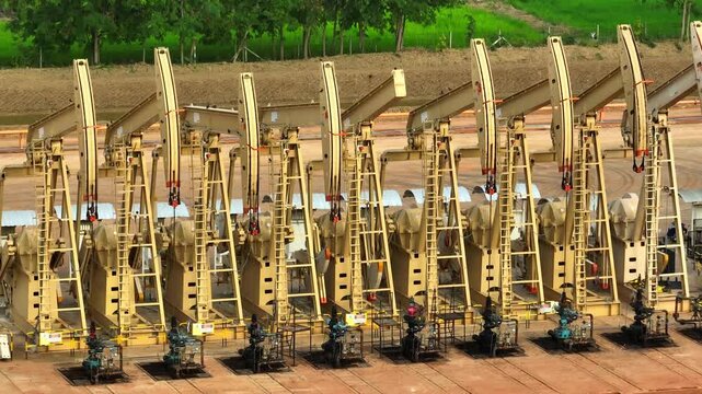 High-resolution aerial shot of active oil pump jacks, symbolizing ongoing crude production, energy security concerns, and the role of oil in supporting industrial and economic systems worldwide.
