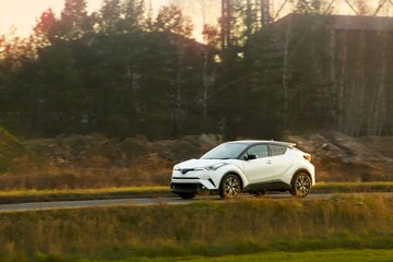 Fototapeta premium Hatchback traveling on rural paved road