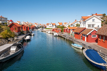 Harbour canal with boats and waterfront houses in Grundsund, Skaftö island, Bohuslän archipelago, west coast of Sweden © TasfotoNL