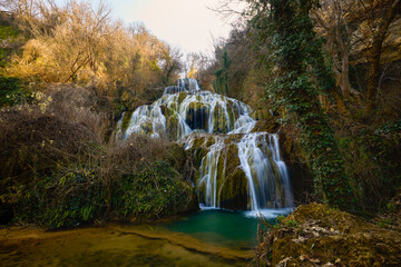Fototapeta premium Landscape with the Krushuna Waterfalls, where the largest natural travertine waterfall in Bulgaria is located.
