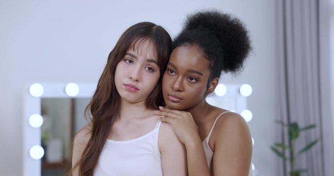 teenage multiracial models leaning on each other slowmotion clip revealing gentle expression skincare softness glowing beauty peaceful moment bonding care modern youth lifestyle confidence