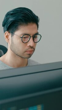 Vertical Screen : Young adult Asia male freelance eyeglasses typing write prompt AI bot app smart program nomad, video game, terminal with coding, user interface, big data center on desktop computer.