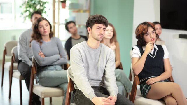 Group of young students paying attention and listening during a classroom training session