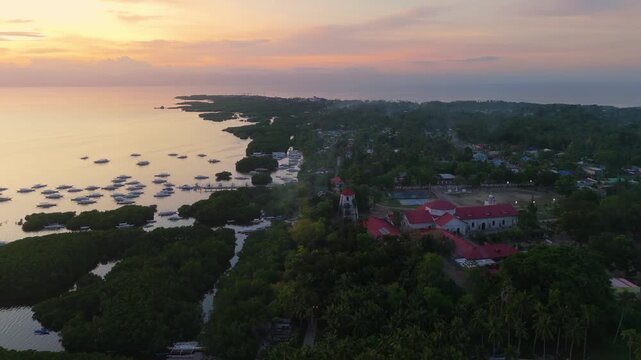 Aerial view of the historic St. Augustine Parish Church and the stone watchtower in Panglao, Bohol