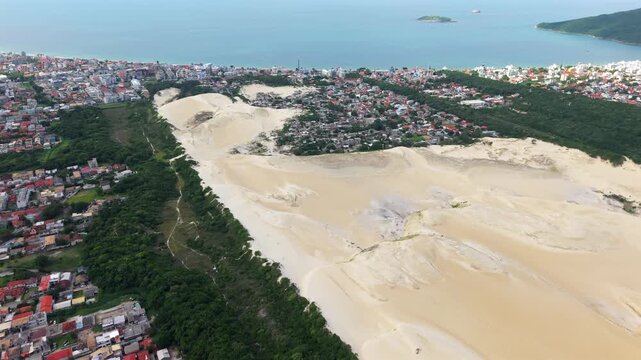 Dunas do Santinho, Praia dos Ingleses and Ilha Mata Fome in Florian&oacute;polis, Brazil, with the vast Atlantic ocean horizon. Upward tilting high aerial.