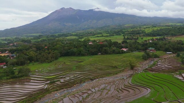 Scenic aerial view of the majestic Mount Canlaon and surrounding verdant forests and farmland in Canlaon City, Negros Oriental, Philippines. High altitude volcanic vista and rice field 
