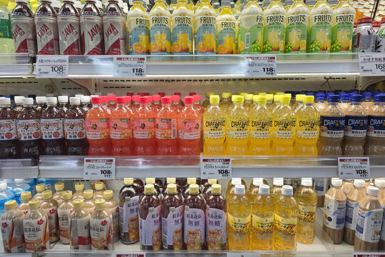 Beppu, Japan - Jan 07, 2026: A variety of Japanese bottled beverages including Craft Boss tea, Java Tea, and various fruit-flavored iced teas neatly arranged on refrigerated grocery store shelves.