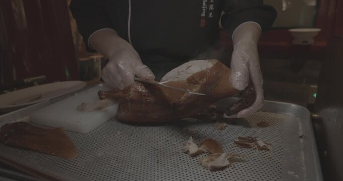 Roasted Peking duck dish being prepared for serving to guests