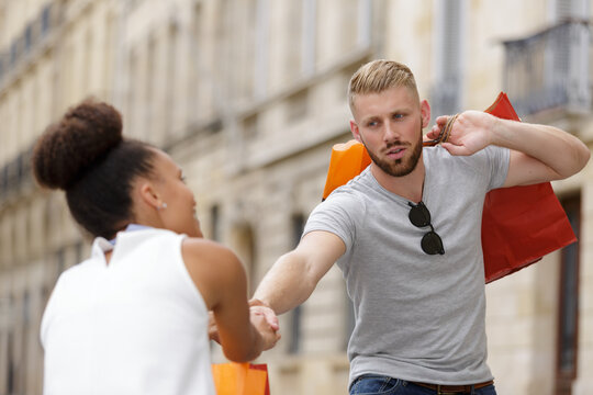 woman dragging her man or boyfriend to do shopping