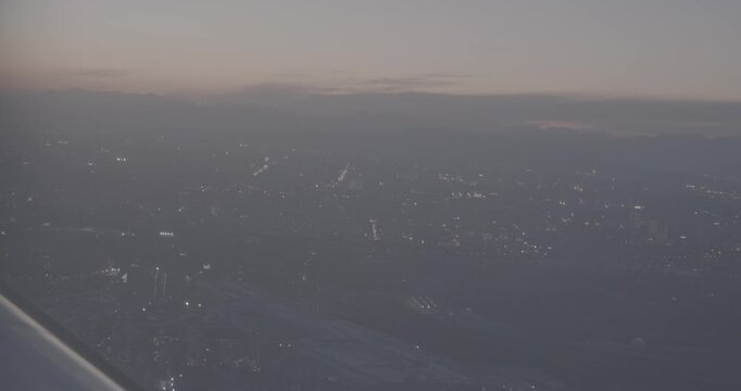 Illuminated City Lights at Dusk with Mountain Backdrop