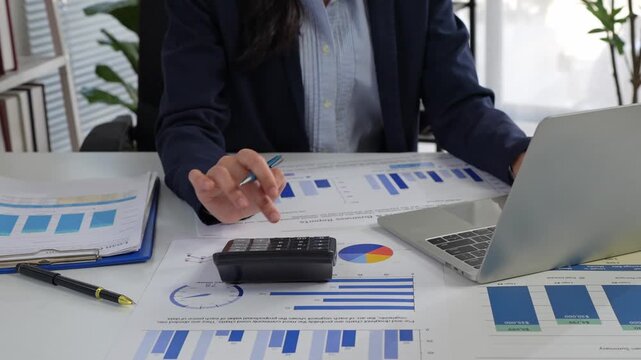Businesswoman calculating finances and analyzing business data