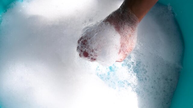 Hands Holding Soap Bubbles in Clean Water, Close-up, Wash hands hygiene, cleanliness, handwashing routine, and disease prevention through proper sanitation