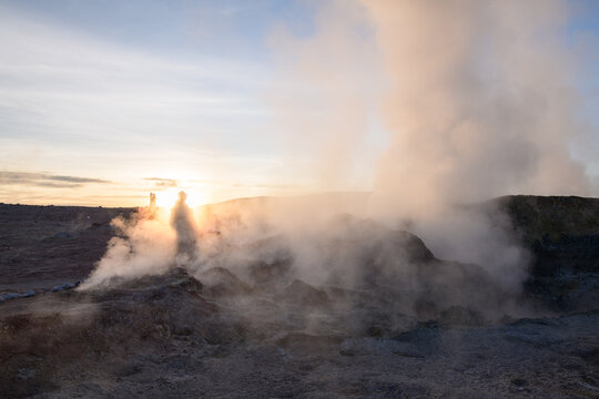 Dramatic geothermal sol de manana geyser field with steam at sunrise