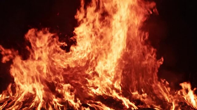 Vibrant orange and red flames burning intensely at night