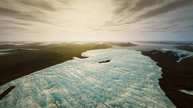 Aerial glacier expanse under golden sky revealing icy textures, scattered floes and distant dark coastline tranquil atmosphere with warm sunlight highlighting