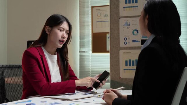 Businesswomen arguing during late night office meeting