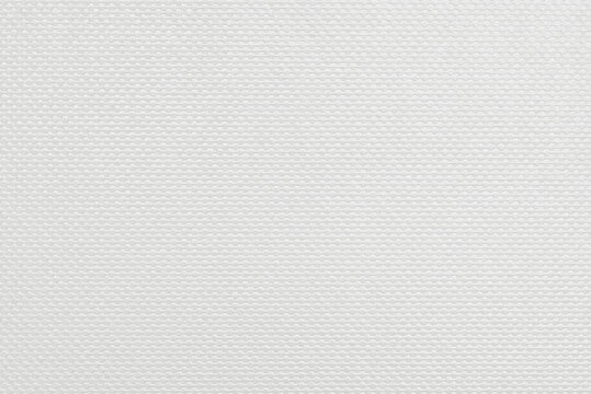 Embossed cardstock background, uniform raised paper pattern