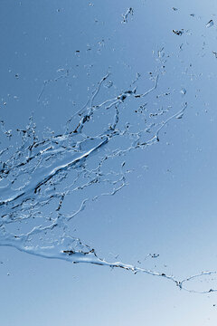 Abstract blue water splash in motion with fluid stream and drops