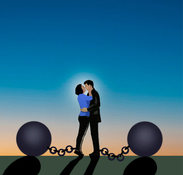 Romantic couple embracing bound by ball and chain at sunset