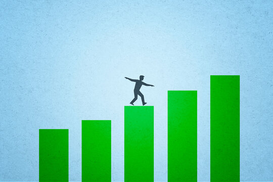 Man balancing on green bar chart illustration representing financial success