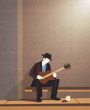 Busker guitarist playing alone at night under a streetlight