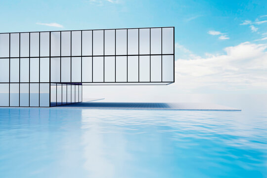 Modern glass building with large windows and terrace by the ocean