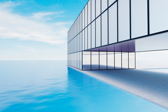 Modern glass building with terrace overlooking tranquil ocean
