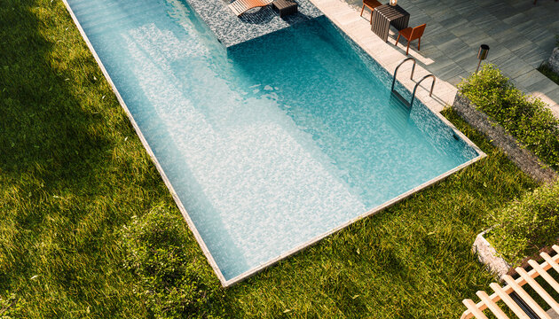 Modern swimming pool in backyard of house on a sunny day