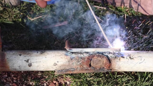 Welding process with bright sparks and smoke