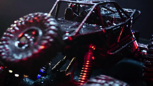 off-road toy cars turn with big tires art creative in water splashes 360 degree rotation on dark background with red backlight