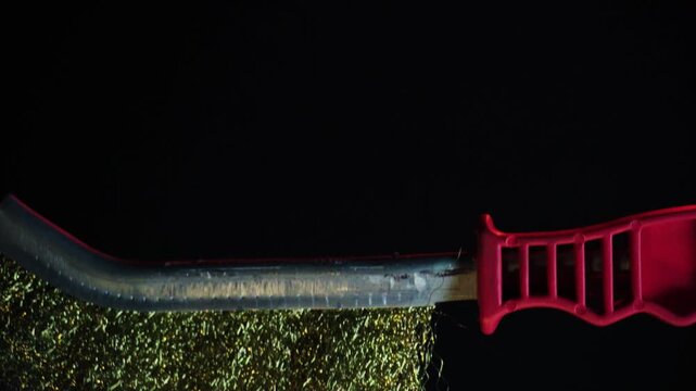 new metal brush with red handle, 360 degree rotation on a dark background with red backlight