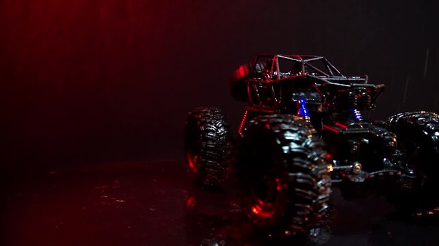 off-road toy cars turn with big tires art creative in water splashes 360 degree rotation on dark background with red backlight