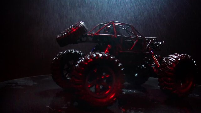 off-road toy cars turn with big tires art creative in water splashes 360 degree rotation on dark background with red backlight