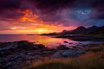 Obraz premium Dramatic Coastal Sunset on Mull: Flaming Twilight and Silhouettes Across the Horizon