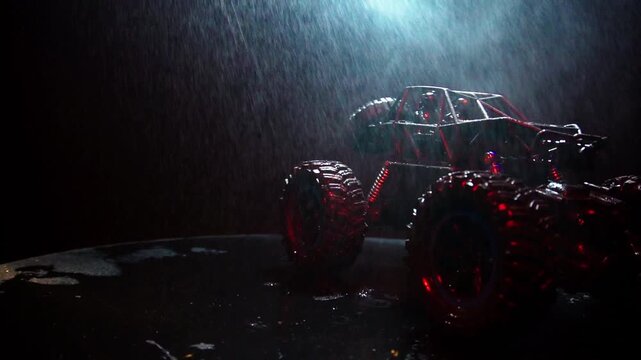 off-road toy cars turn with big tires art creative in water splashes 360 degree rotation on dark background with red backlight