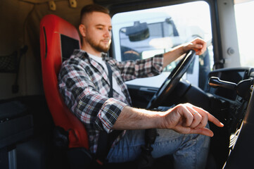 Truck driver operating vehicle in cabin, cargo transport concept