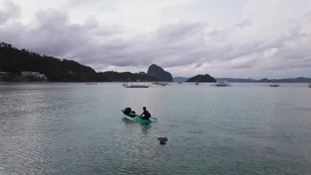Boat tour guide heading to shore in Bacuit Bay El Nido Palawan Philippines