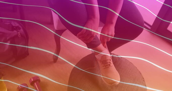 Woman placing foot on ottoman, adjusting sock and tying laces, overlay crossing, preparing workout
