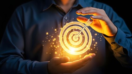 Person's hands are cupping a brightly glowing digital target with an arrow hitting the bullseye, symbolizing successful goal achievement and strategic business focus.