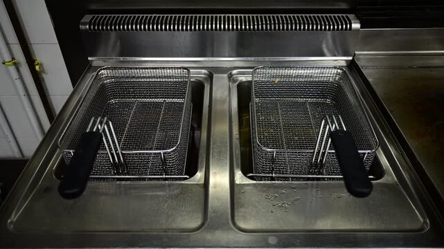 Professional deep fryer slowly advancing in a restaurant kitchen