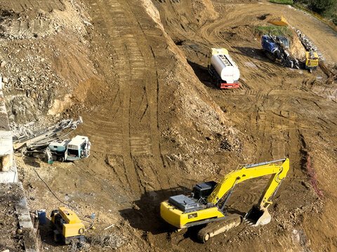 View of construction vehicles carve paths into the earth, a stark contrast against the natural landscape, a scene of industry and progress, Istanbul, Istanbul, Turkey.
