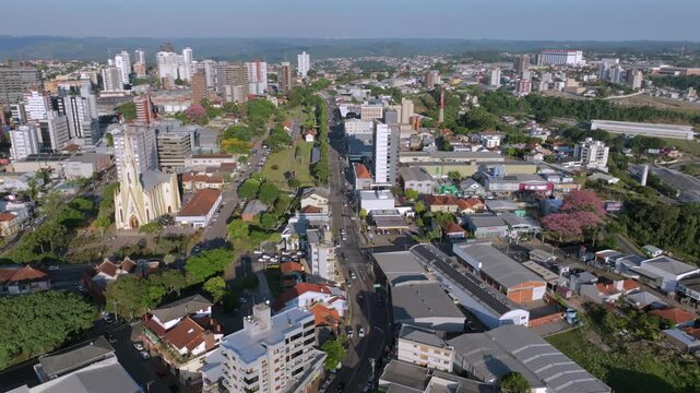 Downtown Bento Gon&ccedil;alves aerial hover with Cristo Rei Church, rail corridor and central streets, captured in D-Log with 10-bit color using a Hasselblad sensor.