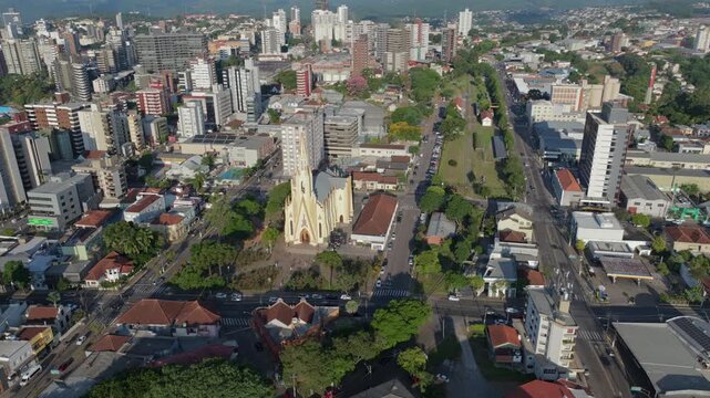 Igreja Matriz Cristo Reiaerial orbit over downtown Bento Gon&ccedil;alves with moving traffic and active urban center, captured in D-Log with 10-bit color using a Hasselblad sensor.