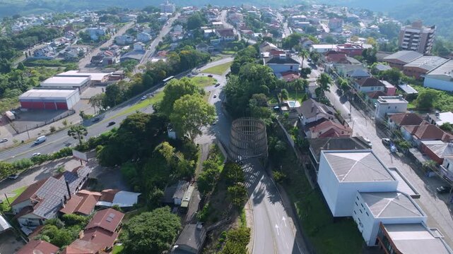 Bento Gon&ccedil;alves portico orbital drone shot showing city access road and highway connection, captured in D-Log with 10-bit color using a Hasselblad sensor.